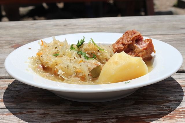 big dish of pork, sauerkraut, and mashed potatoes